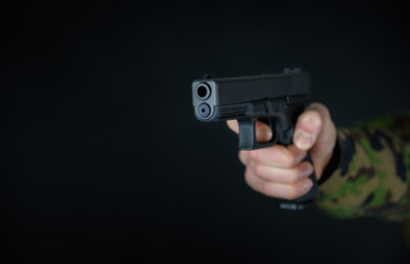 Soldier holds gun in the hand