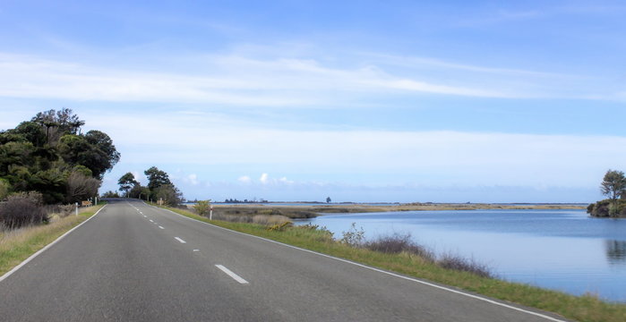 Landscape image of a scenic open road in the Golden Bay region of New Zealand.
