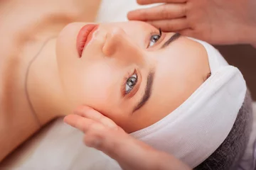 Store enrouleur Salon de beauté Beautiful young female face during facial procedure