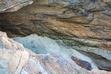 Geological sediment layers in the rock at Wharariki Beach. Wharariki Beach is a beach west of Cape Farewell, the northernmost point of the South Island of New Zealand.