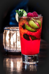 Fruit on alcoholic cocktail in a bar environment