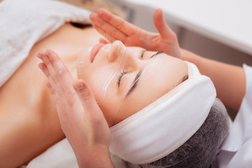 Pleasant beautiful nice woman treating her skin