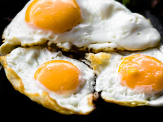 Thai styled perfectly crispy street food fried eggs on black background