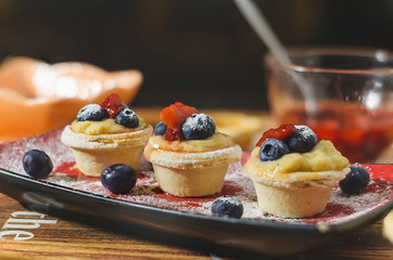 tart stuffed with cream, berries and jam of fresh strawberries