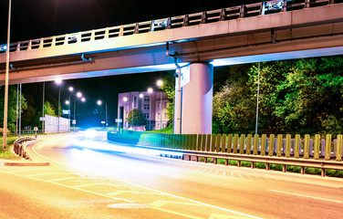 Fototapeta premium Asphalt road and Elevated Bridge at night