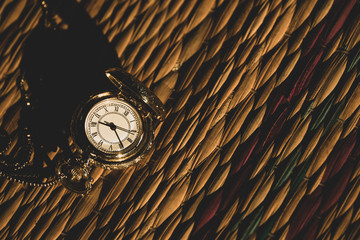 Vintage Pocket watch with morning light on match floor