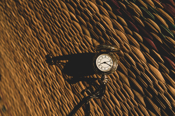 Vintage Pocket watch with morning light on match floor