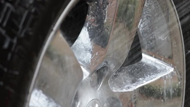Spray from water hose is hitting crome wheel and suds running off.