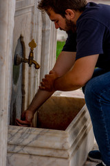 The man washing his hands preparing for the pray