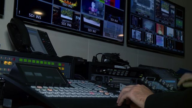 Broadcast Technician Operates Video Switcher on Live News Coverage