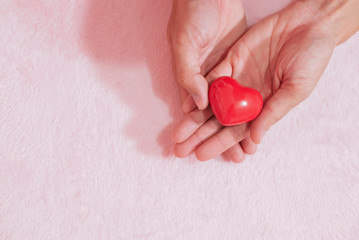 Top view hand holding red heart for valentine day concept, romantic love forever.