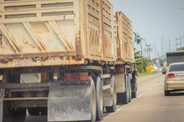 Cars on the right lane are speed to overtaking truck on the left lane.