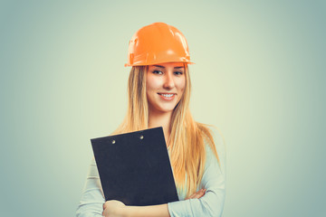 woman in hardhat holding clipboard