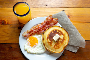 American breakfast with egg, pancake and bacon
