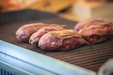 Grilled Yakiimo, Traditional Japanese Sweet Potato Roasted for Sale in the restaurant. Roasted sweet potato is a popular winter street food in East Asia.