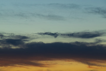 Fototapeta na wymiar Blue and orange cloudy sunset sky.