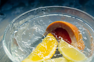 tropical fruits citrus fall deeply under water with a big splash