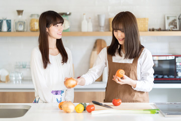 attractive asian women cooking in kitchen