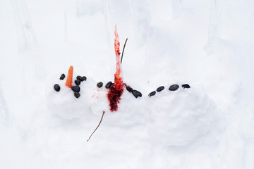 Bloody dead snowman impaled on a sharp icicle during a winter storm