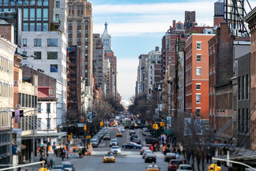 View of a busy 14th Street in the Chelsea neighborhood with people and traffic in New York City NYC