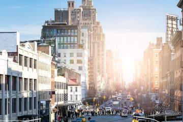 Busy view of 14th Street with crowds of people and sunlight background scene from the Highline Park...
