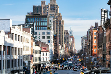 Busy view of 14th Street with crowds of people scene from the Highline Park in Chelsea New York...
