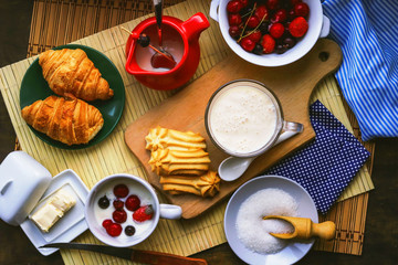 fresh breakfast foods. milk yogurt, croissants and frozen berries.