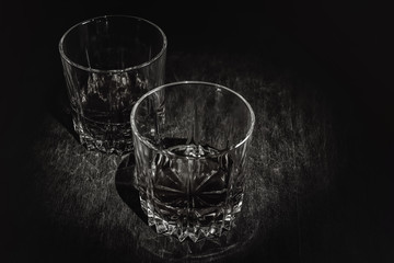 Whiskey in a glass on a dark wooden background.