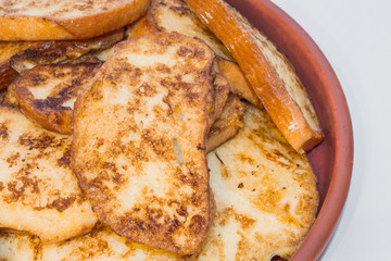 Pieces of toasted bread prepared on the pan. Toasts on the plate.