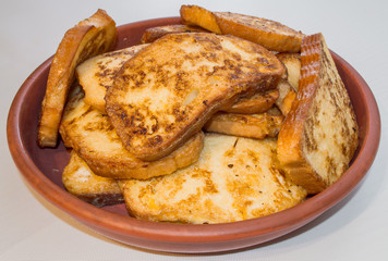 Pieces of toasted bread prepared on the pan. Toasts on the plate.