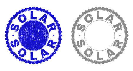Grunge SOLAR stamp seals isolated on a white background. Rosette seals with grunge texture in blue and grey colors. Vector rubber stamp imprint of SOLAR text inside round rosette.