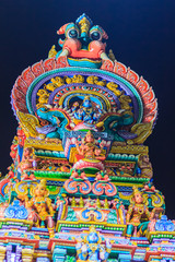 Colorful night view of indian gods sculpture at Sri Maha Mariamman Temple, also known as Maha Uma Devi temple, the public hindu temple in Silom, Bangkok, Thailand. It known as Wat Khaek Silom.