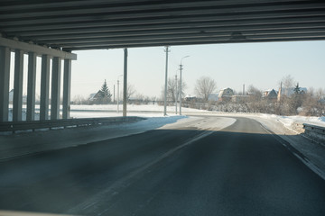 The road in winter. Asphalt road in winter. Road under the snow.
