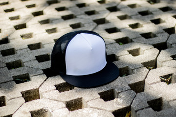Mesh hat cap flat visor with black and white color in outdoor, ready for your mock up design or...