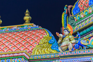 Colorful night view of indian gods sculpture at Sri Maha Mariamman Temple, also known as Maha Uma Devi temple, the public hindu temple in Silom, Bangkok, Thailand. It known as Wat Khaek Silom.
