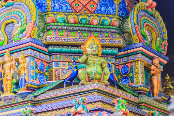 Colorful night view of indian gods sculpture at Sri Maha Mariamman Temple, also known as Maha Uma Devi temple, the public hindu temple in Silom, Bangkok, Thailand. It known as Wat Khaek Silom.