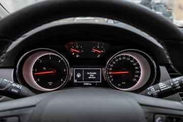 Car front instrument panel with warning of slippery roads.