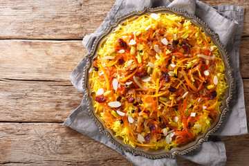 Javaher Polow (jeweled rice) is a traditional Persian rice dish closeup on a plate. horizontal top...