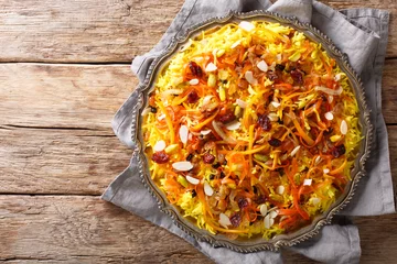 Fototapeten Javaher Polow (jeweled rice) is a traditional Persian rice dish closeup on a plate. horizontal top view © FomaA