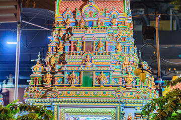 Colorful night view of indian gods sculpture at Sri Maha Mariamman Temple, also known as Maha Uma Devi temple, the public hindu temple in Silom, Bangkok, Thailand. It known as Wat Khaek Silom.