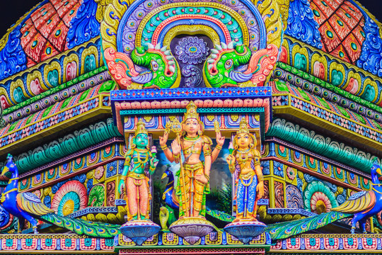 Colorful night view of indian gods sculpture at Sri Maha Mariamman Temple, also known as Maha Uma Devi temple, the public hindu temple in Silom, Bangkok, Thailand. It known as Wat Khaek Silom.