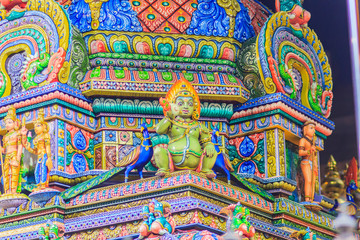 Colorful night view of indian gods sculpture at Sri Maha Mariamman Temple, also known as Maha Uma Devi temple, the public hindu temple in Silom, Bangkok, Thailand. It known as Wat Khaek Silom.