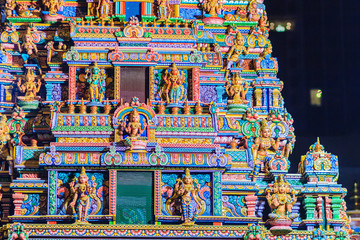 Colorful night view of indian gods sculpture at Sri Maha Mariamman Temple, also known as Maha Uma Devi temple, the public hindu temple in Silom, Bangkok, Thailand. It known as Wat Khaek Silom.