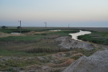 Spring landscape with river and clouds on the blue sky
