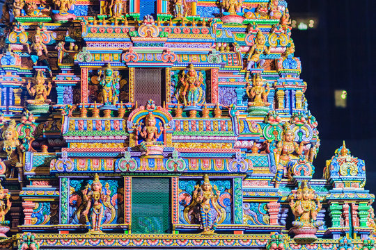 Colorful night view of indian gods sculpture at Sri Maha Mariamman Temple, also known as Maha Uma Devi temple, the public hindu temple in Silom, Bangkok, Thailand. It known as Wat Khaek Silom.