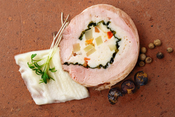 quail galantine, de-boned stuffed meat for a festive dinner on a rustic brick plate, copy space,...