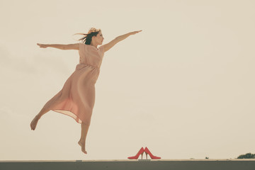 Fototapeta premium Woman dancing wearing long light pink dress