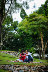Joyful young loving couple spending time together study at the park. Leisure and enjoy the day