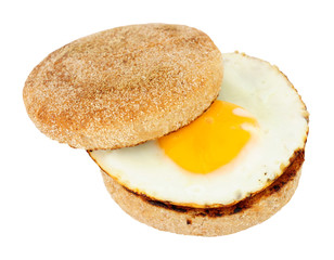 Fried egg on a soft toasted wholemeal English muffin isolated on a white background