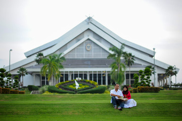 Joyful young loving couple spending time together study at the park. Leisure and enjoy the day